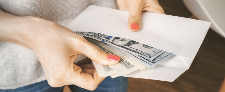 Woman pulling cash out of an envelope