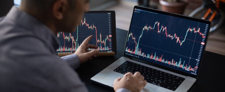 Man checking stock returns on his laptop