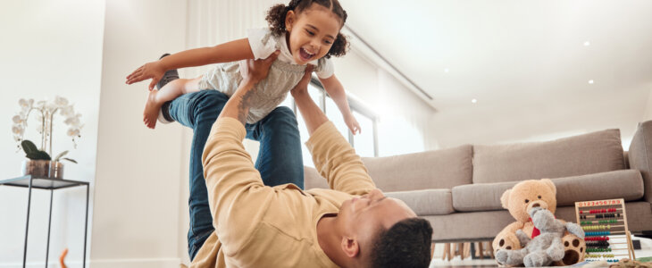 Happy family, father and girl playing in a house, bonding and enjoying quality time together.